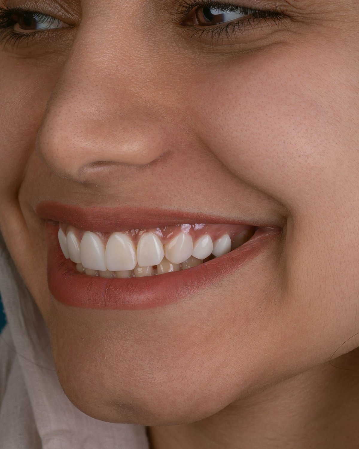 A close-up of a woman's wide, natural smile